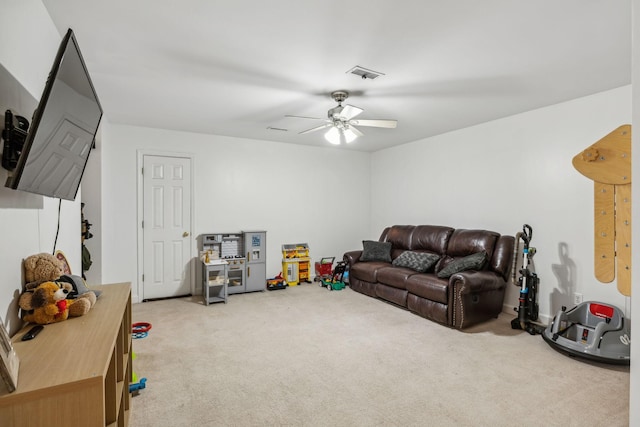 carpeted living room with ceiling fan