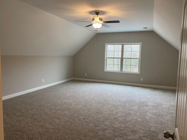 additional living space with carpet flooring, ceiling fan, and vaulted ceiling