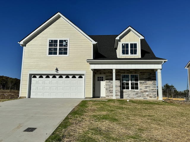 view of front of house featuring a garage and a front lawn