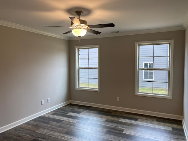 spare room with ceiling fan, a healthy amount of sunlight, dark hardwood / wood-style flooring, and crown molding