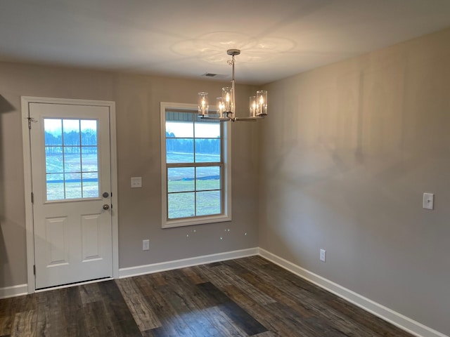 interior space featuring dark hardwood / wood-style floors, a wealth of natural light, and a notable chandelier