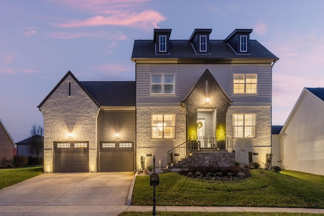 view of front of home featuring a garage and a yard