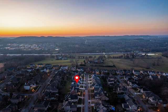 aerial view at dusk featuring a mountain view