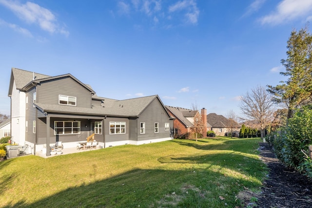 rear view of house with a yard and a patio area