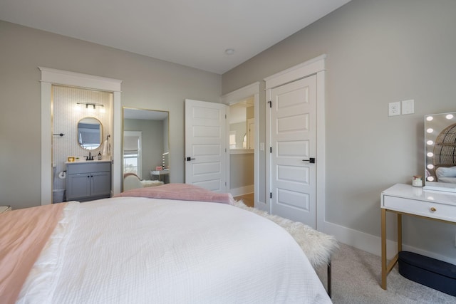 carpeted bedroom featuring connected bathroom