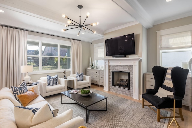 living room with beamed ceiling, hardwood / wood-style flooring, ornamental molding, a notable chandelier, and a brick fireplace