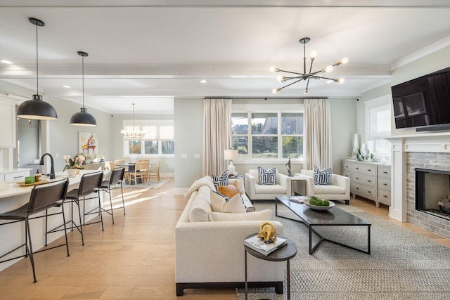 living room with an inviting chandelier and light hardwood / wood-style floors