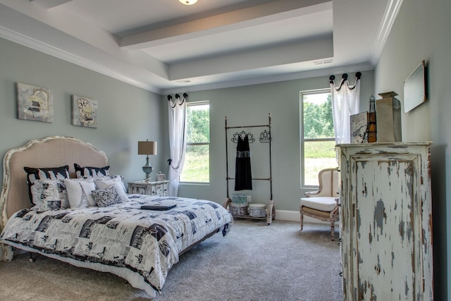 bedroom featuring ornamental molding, carpet flooring, and a tray ceiling