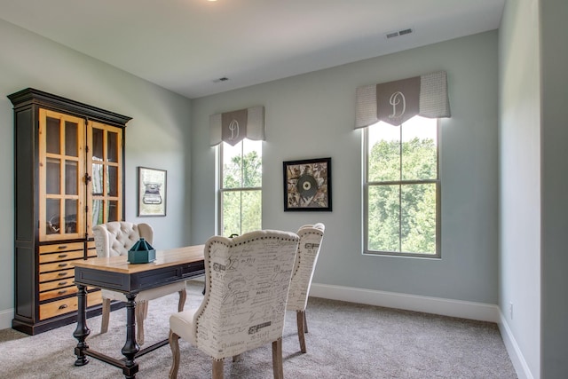 home office with plenty of natural light and carpet flooring