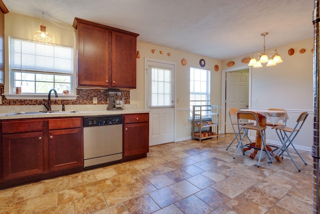 kitchen with a wealth of natural light, dishwasher, a chandelier, and sink