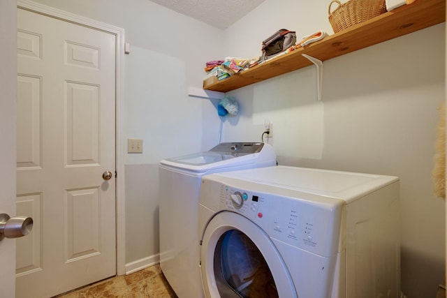 washroom featuring independent washer and dryer and a textured ceiling