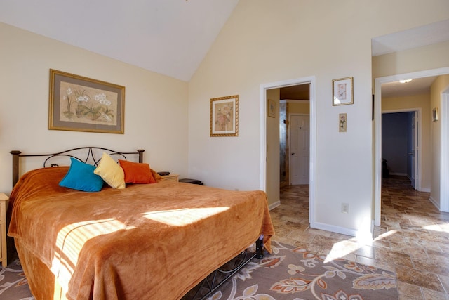 bedroom with high vaulted ceiling