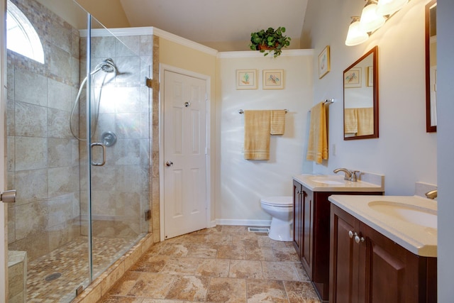 bathroom featuring vanity, toilet, and a shower with shower door