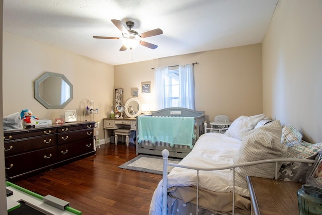 bedroom featuring ceiling fan and dark hardwood / wood-style floors