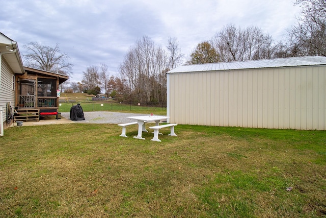 view of yard with an outdoor structure and a sunroom