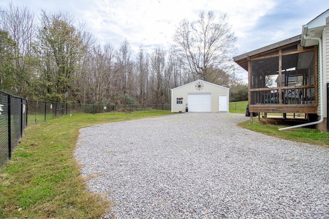 exterior space featuring a garage, an outdoor structure, and a deck