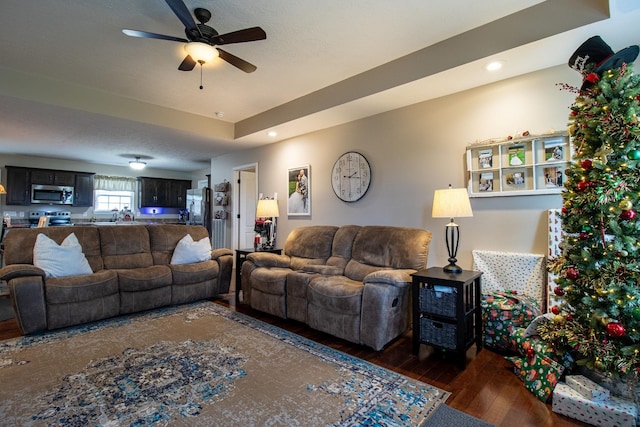 living room featuring dark hardwood / wood-style floors and ceiling fan