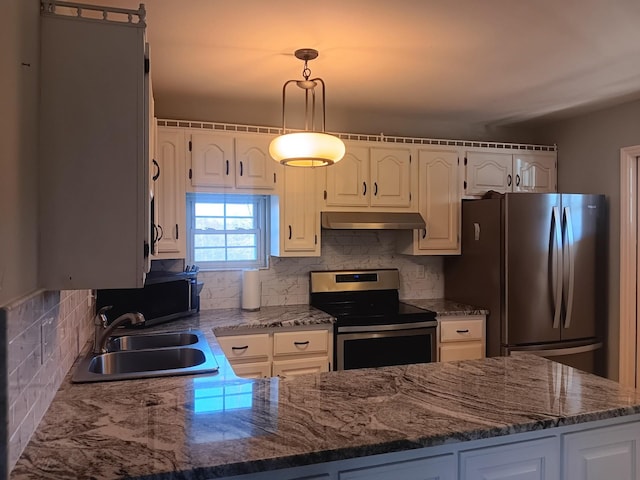 kitchen featuring decorative backsplash, appliances with stainless steel finishes, sink, pendant lighting, and white cabinets