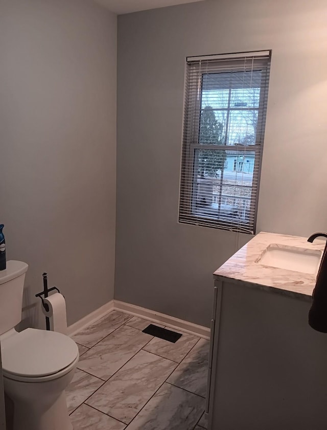 bathroom featuring vanity and toilet