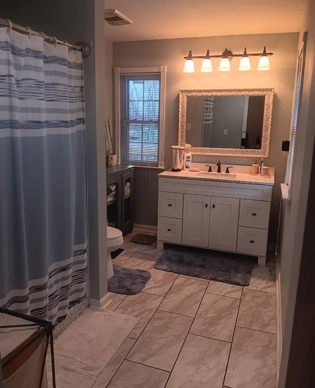 bathroom featuring vanity and toilet