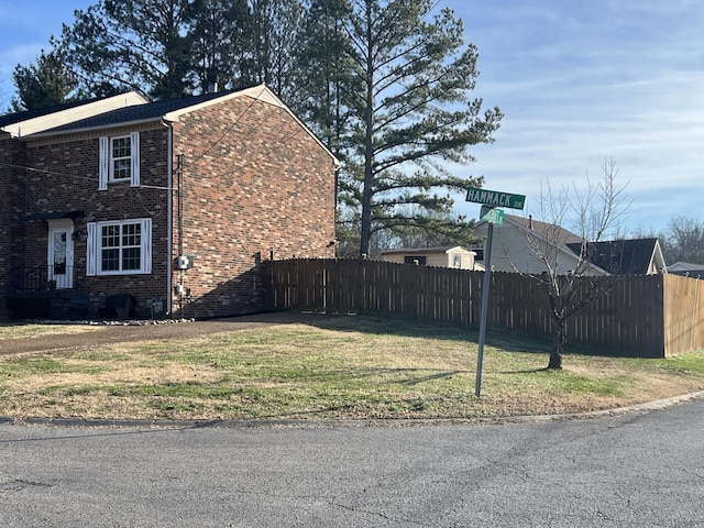 view of side of property with a lawn