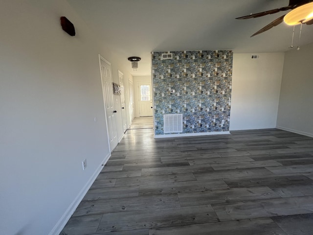 spare room featuring dark hardwood / wood-style floors and ceiling fan