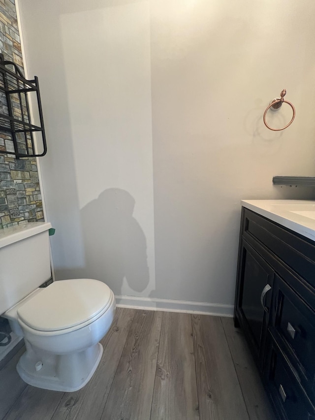 bathroom featuring hardwood / wood-style floors, vanity, and toilet