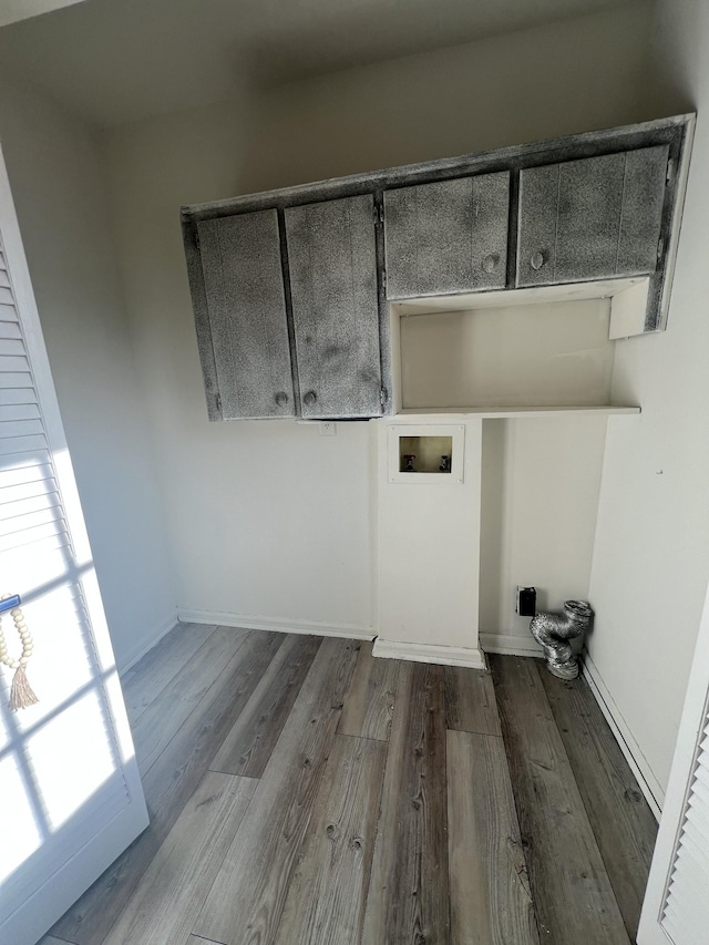 laundry area with cabinets, washer hookup, and wood-type flooring