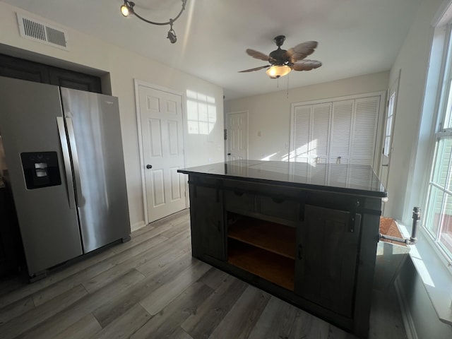 kitchen with stainless steel fridge with ice dispenser, ceiling fan, and dark wood-type flooring