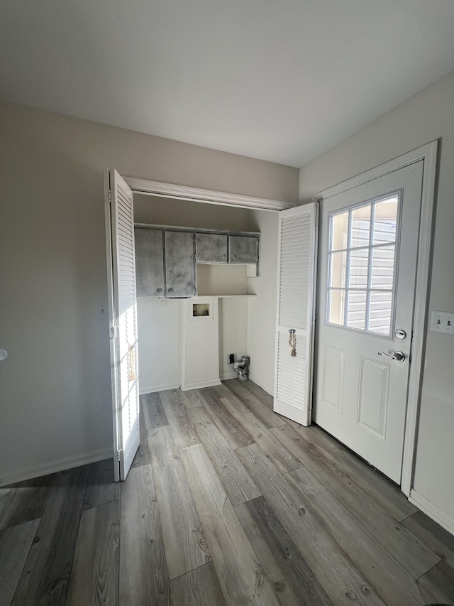 laundry room featuring cabinets, hookup for a washing machine, and wood-type flooring