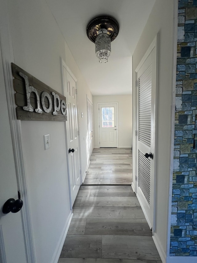 hallway with hardwood / wood-style flooring