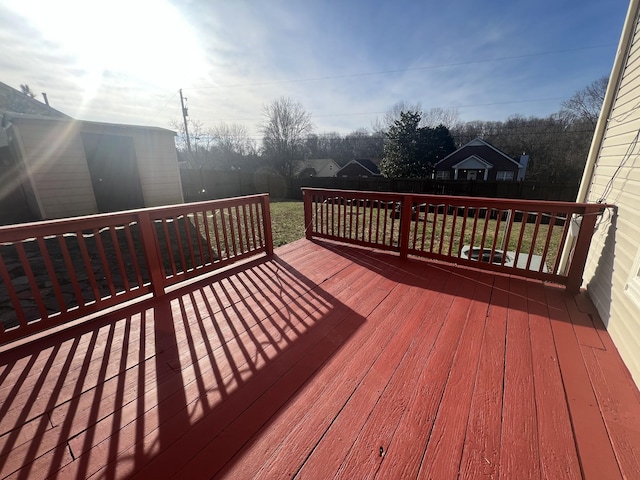 wooden terrace featuring a lawn