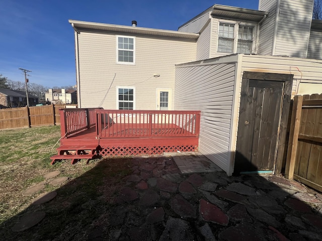 rear view of property featuring a deck