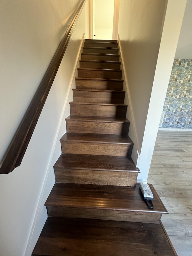 stairs featuring hardwood / wood-style floors