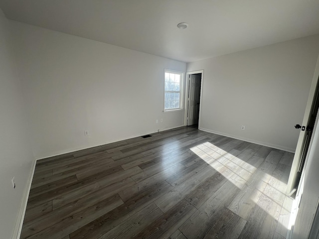 unfurnished room featuring dark hardwood / wood-style floors