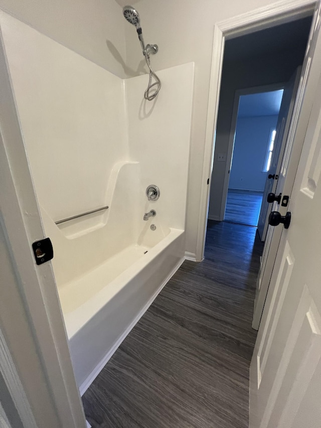 bathroom with hardwood / wood-style floors and shower / tub combination