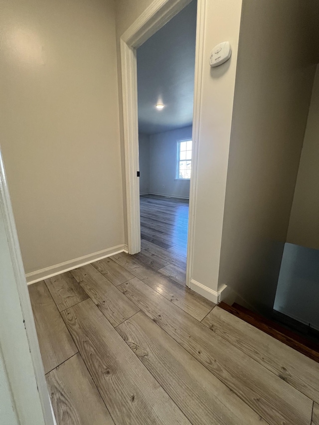 corridor with light hardwood / wood-style flooring