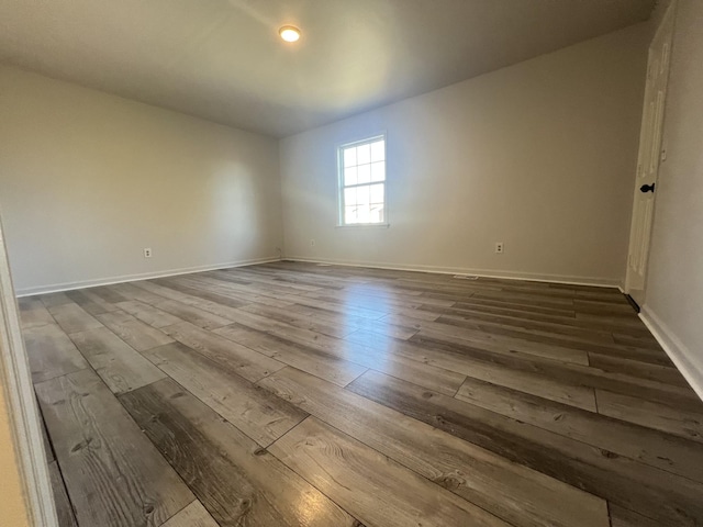 empty room with hardwood / wood-style floors