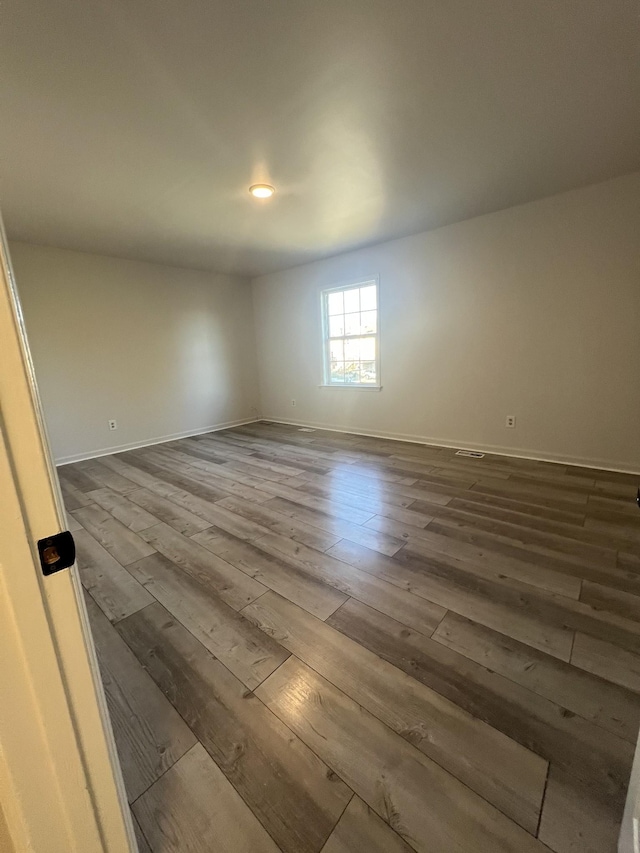 empty room with wood-type flooring