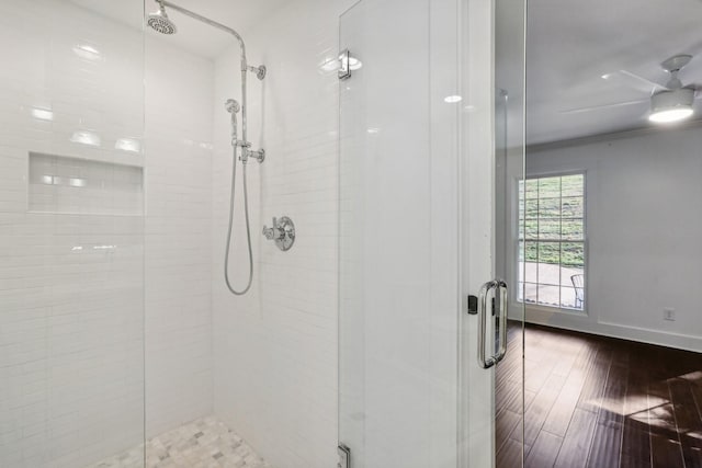 bathroom with ceiling fan, wood-type flooring, and walk in shower