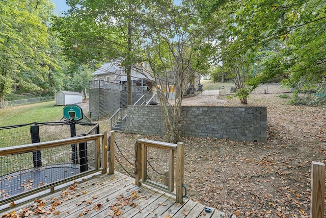 wooden terrace featuring a shed