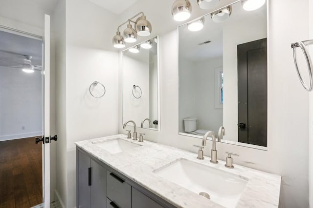 bathroom with ceiling fan, toilet, and vanity