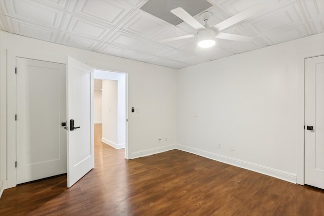 unfurnished bedroom with ceiling fan and dark wood-type flooring