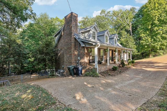 view of side of property with central air condition unit and covered porch