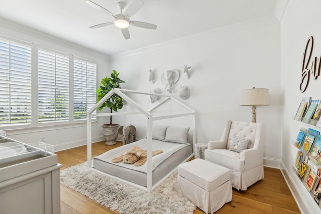 interior space with light hardwood / wood-style flooring, ceiling fan, and crown molding