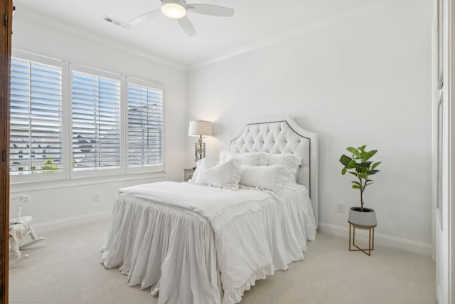 carpeted bedroom featuring multiple windows, ceiling fan, and ornamental molding