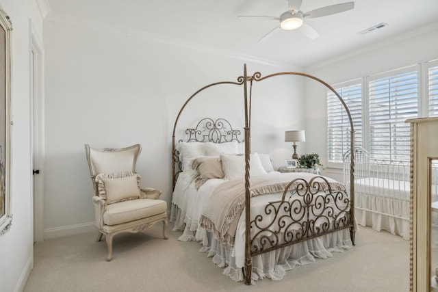 carpeted bedroom with ceiling fan and crown molding