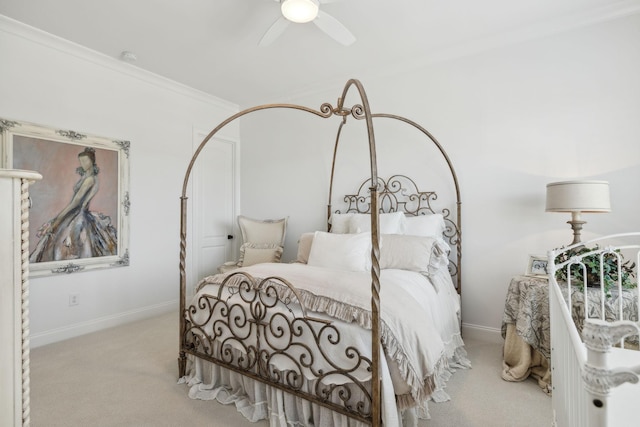 carpeted bedroom with ceiling fan and crown molding