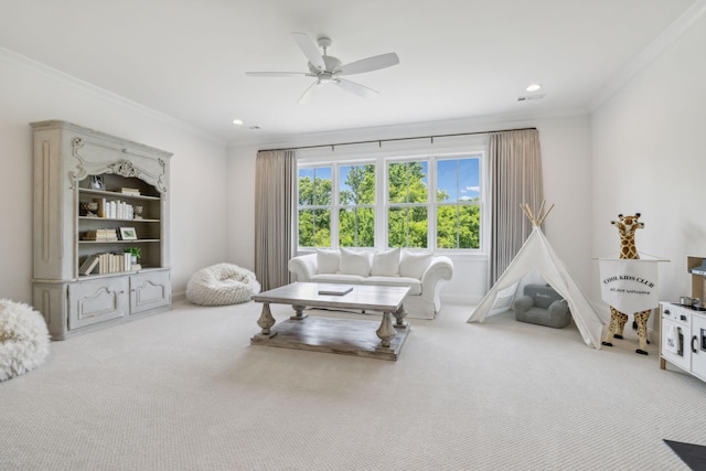 sitting room featuring carpet flooring, crown molding, and ceiling fan