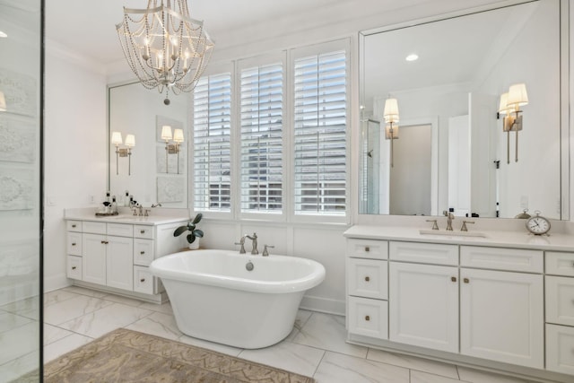 bathroom featuring a chandelier, vanity, a bath, and ornamental molding